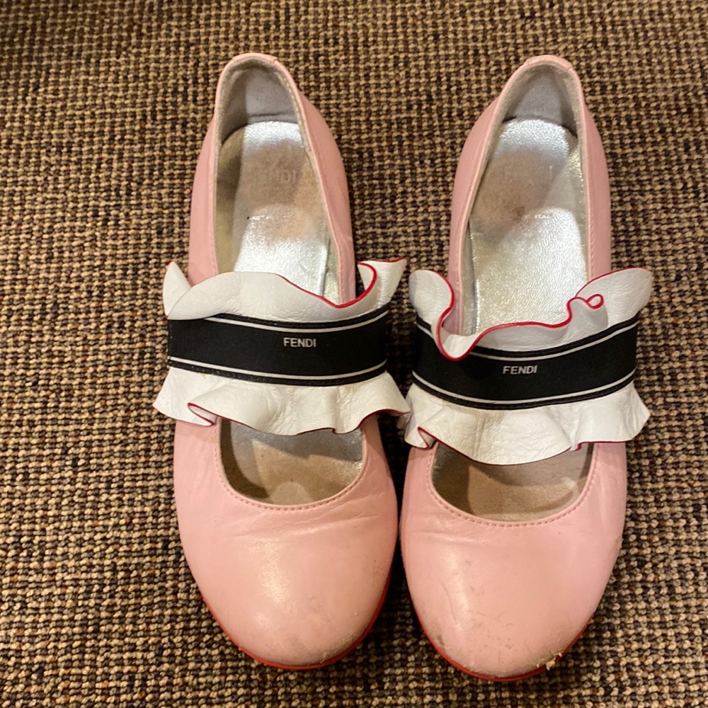 Pink fendi kids flats with white ruffle.